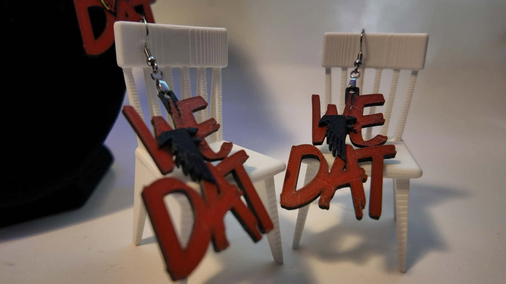 We Dat Atlanta Falcons 3D printed earrings styled on mini chair props